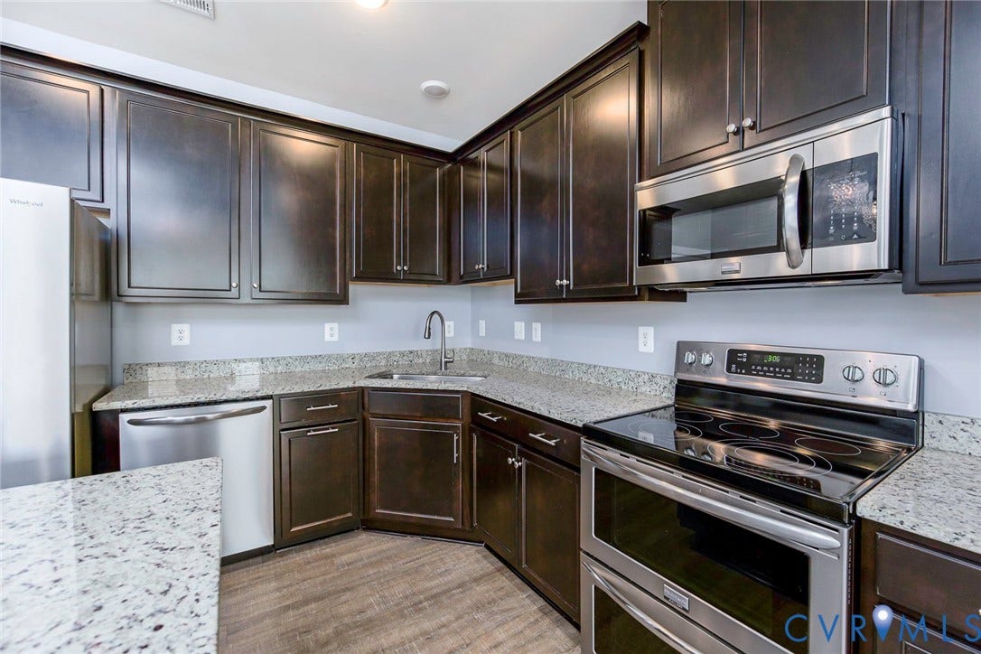 4300 Bon Secours Parkway, #A, Henrico, VA 23233 Stainless steel appliances, wood-finish flooring, dark wood cabinetry, light-toned countertops, and a double-oven range