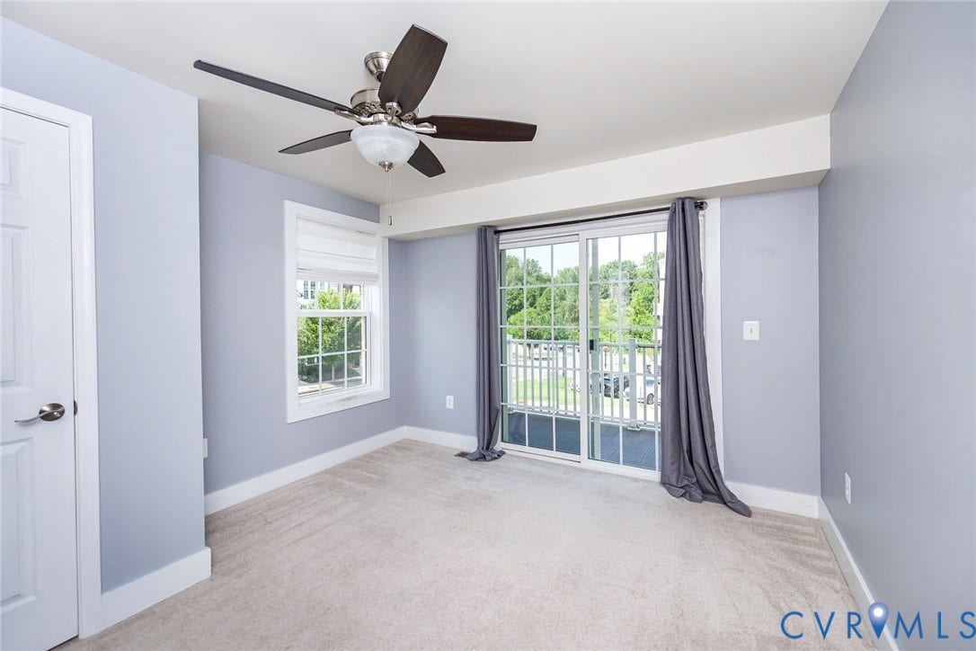4300 Bon Secours Parkway, #A, Henrico, VA 23233 Ceiling fan with light fixture, sliding glass door, white trim work, light-colored carpet, and a large window
