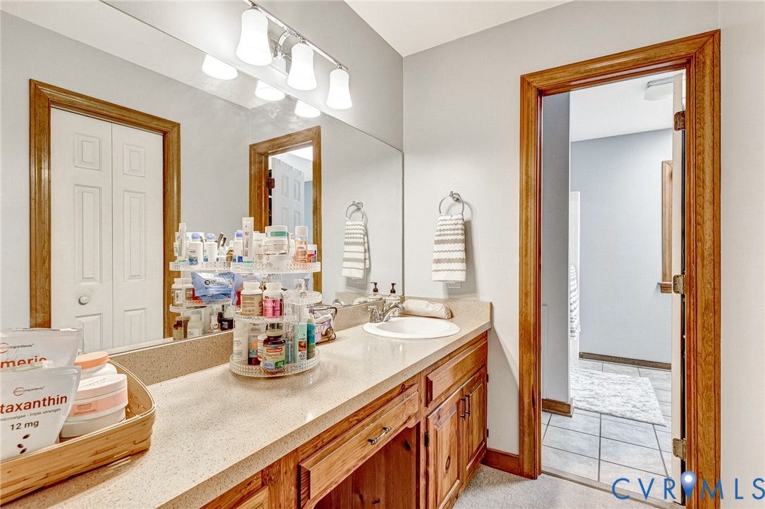 Extended vanity with an integrated sink and light-toned countertop