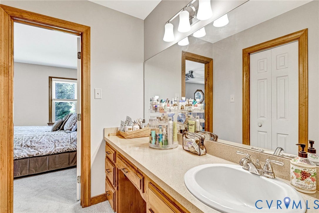 Vanity with an integrated sink, polished chrome faucet, and ample counter space