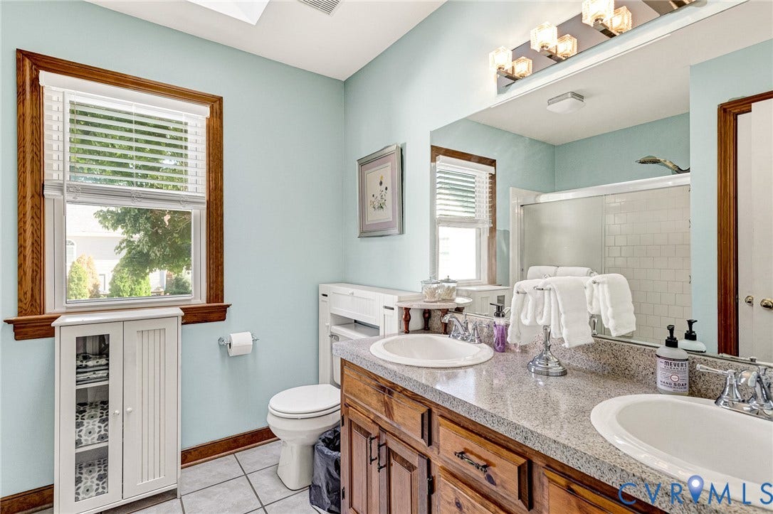 Double vanity with undermount sinks and a speckled countertop