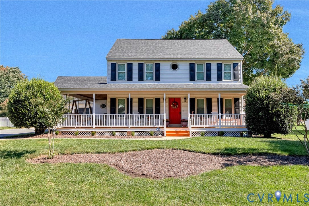 Two-story residence with a covered front porch, white siding, and a red entry door