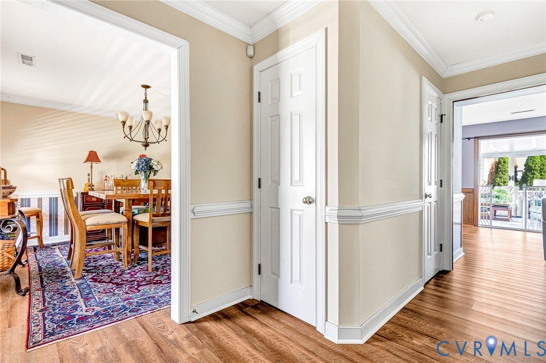 Wood-finish flooring, crown molding, chair rail, panel doors, and sliding glass doors