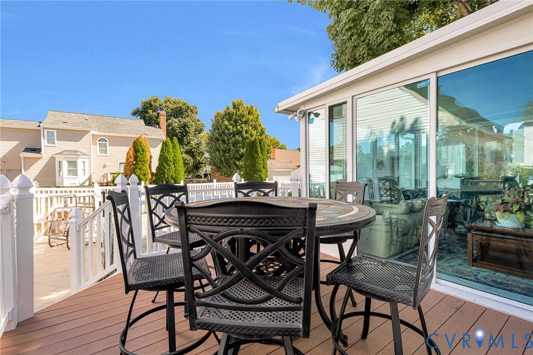 Expansive outdoor deck with composite decking and white picket railing