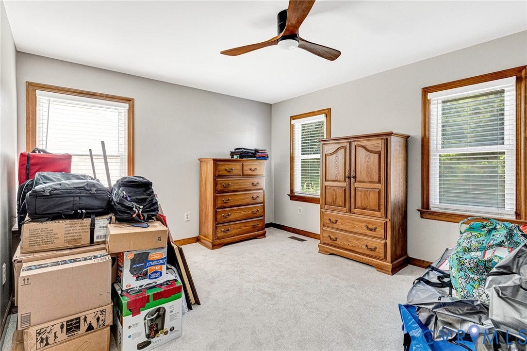 Recessed lighting, light gray wall paint, and a ceiling fan with wood-finish blades