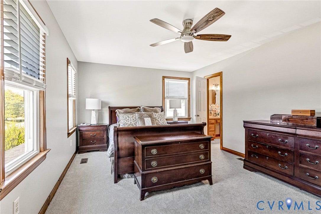 Recessed lighting, ceiling fan with wood-finish blades, and neutral gray wall paint