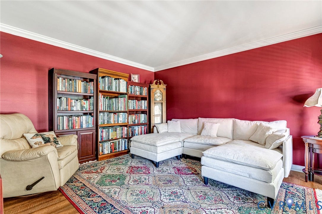 Crown molding with a vibrant wall color, recessed lighting, and wood-finish flooring