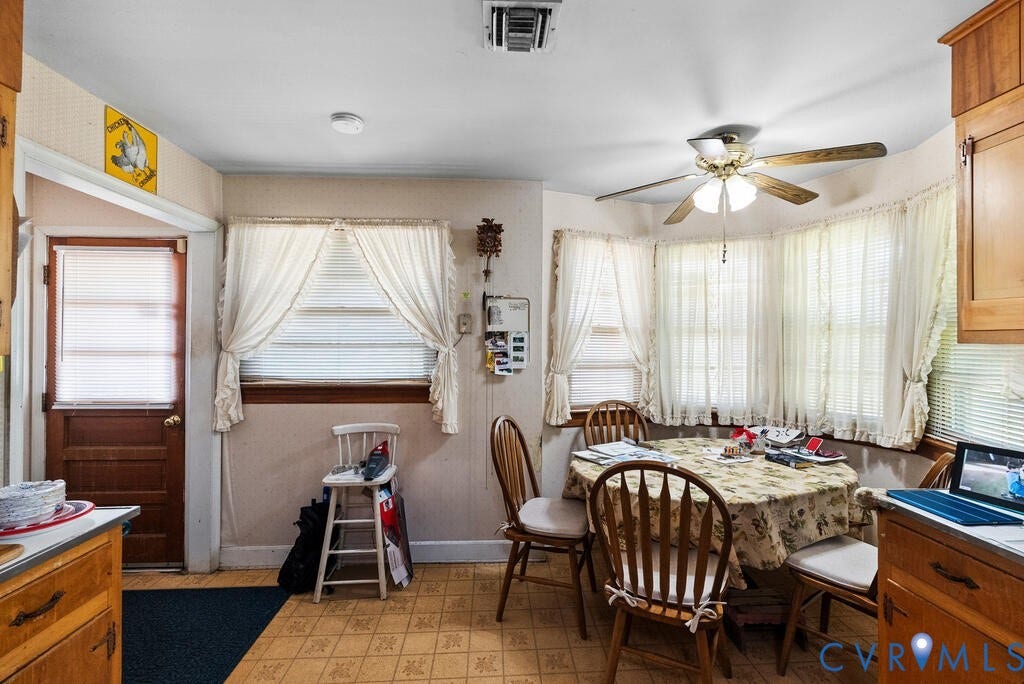 21 Vanderpool Lane, Detached, Cumberland, VA 23040 Bay window with multiple window treatments, ceiling fan with light fixture, wood-finish cabinetry, and patterned floor tiles