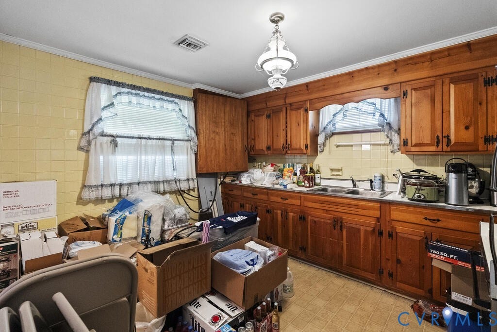 21 Vanderpool Lane, Detached, Cumberland, VA 23040 Kitchen featuring wood cabinetry, a tile backsplash, a single-basin sink, and a multi-light ceiling fixture