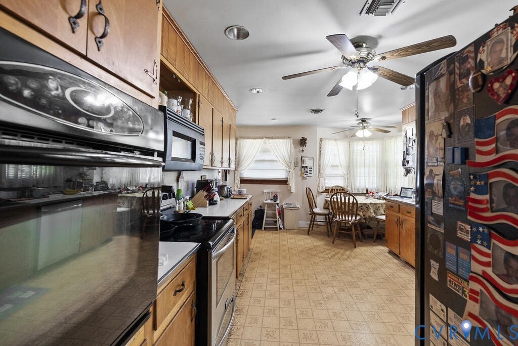 21 Vanderpool Lane, Detached, Cumberland, VA 23040 Galley kitchen featuring wood cabinetry, stainless steel wall oven, built-in microwave, and patterned flooring