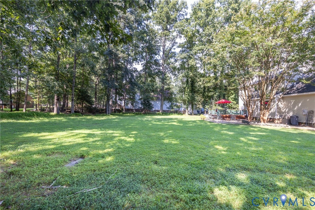 13802 Rockhaven Drive, Thornhill, Chester, VA 23836 Expansive backyard with a large lawn, mature trees, and a stone patio