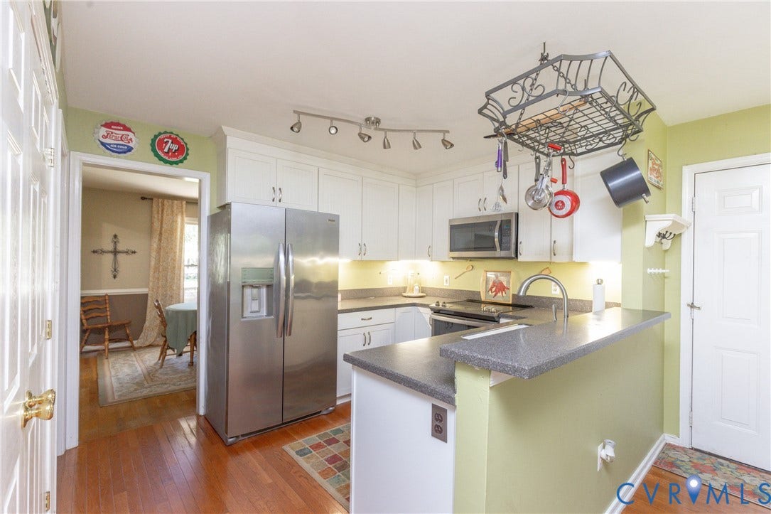 13802 Rockhaven Drive, Thornhill, Chester, VA 23836 Kitchen featuring wood-finish flooring, white cabinetry, stainless steel appliances, and a breakfast bar