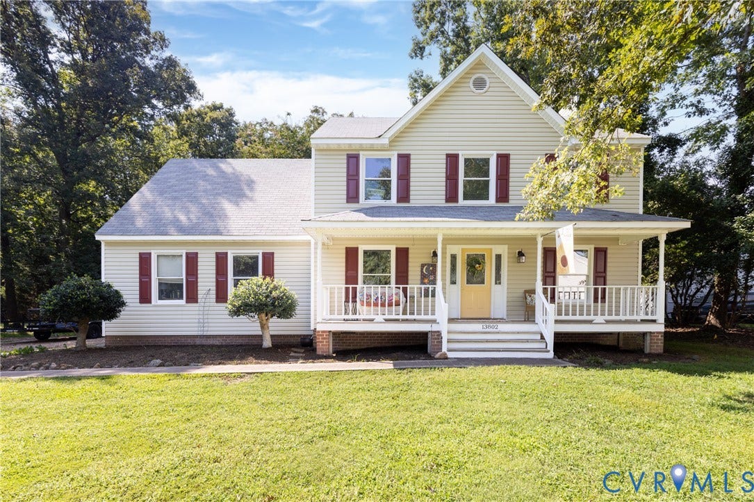 13802 Rockhaven Drive, Thornhill, Chester, VA 23836 Two-story home with a prominent gabled roofline, light-colored horizontal siding, and dark red window shutters