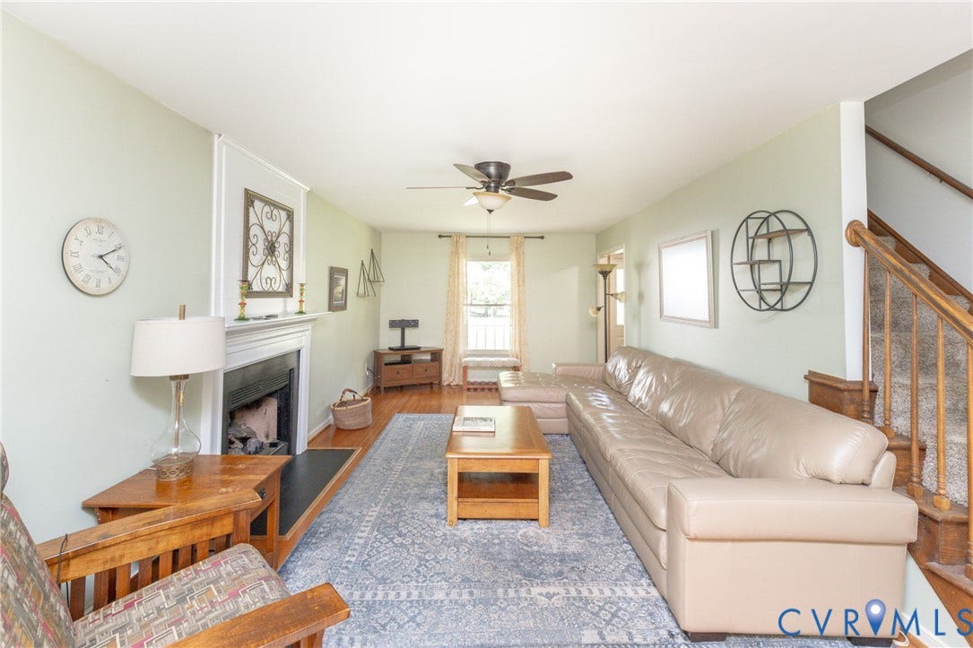 13802 Rockhaven Drive, Thornhill, Chester, VA 23836 Living area featuring wood-finish flooring, a fireplace with a mantel, a ceiling fan, and a staircase with wood railings