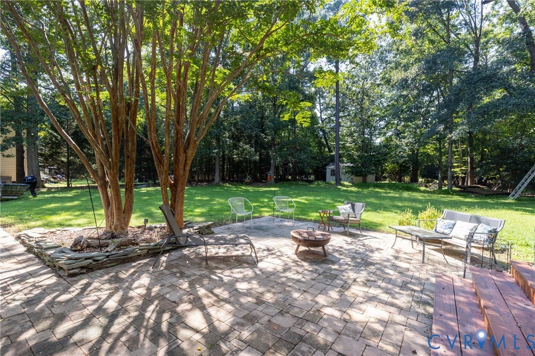 13802 Rockhaven Drive, Thornhill, Chester, VA 23836 Expansive backyard featuring a paver patio, wood steps, and mature trees