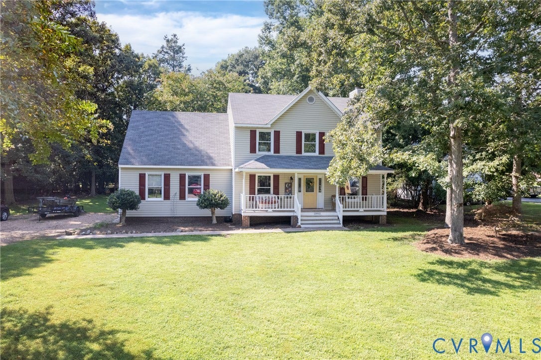 13802 Rockhaven Drive, Thornhill, Chester, VA 23836 Two-story property featuring light-colored siding with contrasting red shutters, a welcoming covered front porch, and a gravel driveway