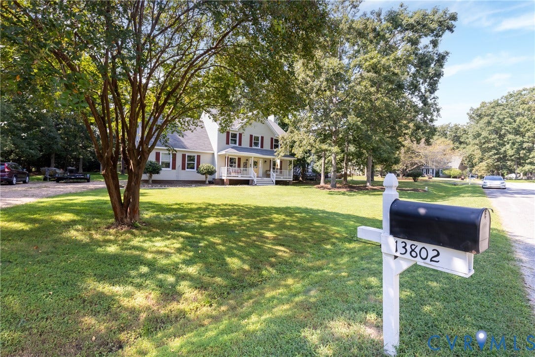 13802 Rockhaven Drive, Thornhill, Chester, VA 23836 Two-story residence with a covered porch, red shutters, and white siding