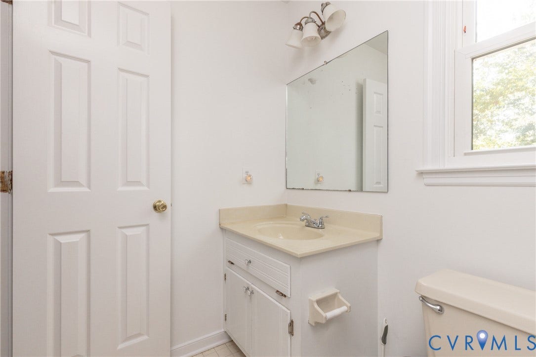 13802 Rockhaven Drive, Thornhill, Chester, VA 23836 Vanity with a built-in sink, wall-mounted mirror, and overhead lighting fixture
