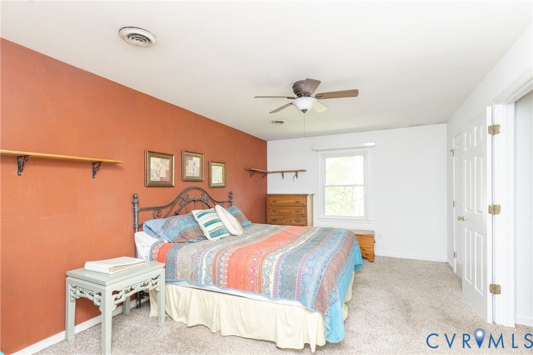 13802 Rockhaven Drive, Thornhill, Chester, VA 23836 Carpeted flooring, ceiling fan, white paneled doors, window with white trim, and wall-mounted shelving