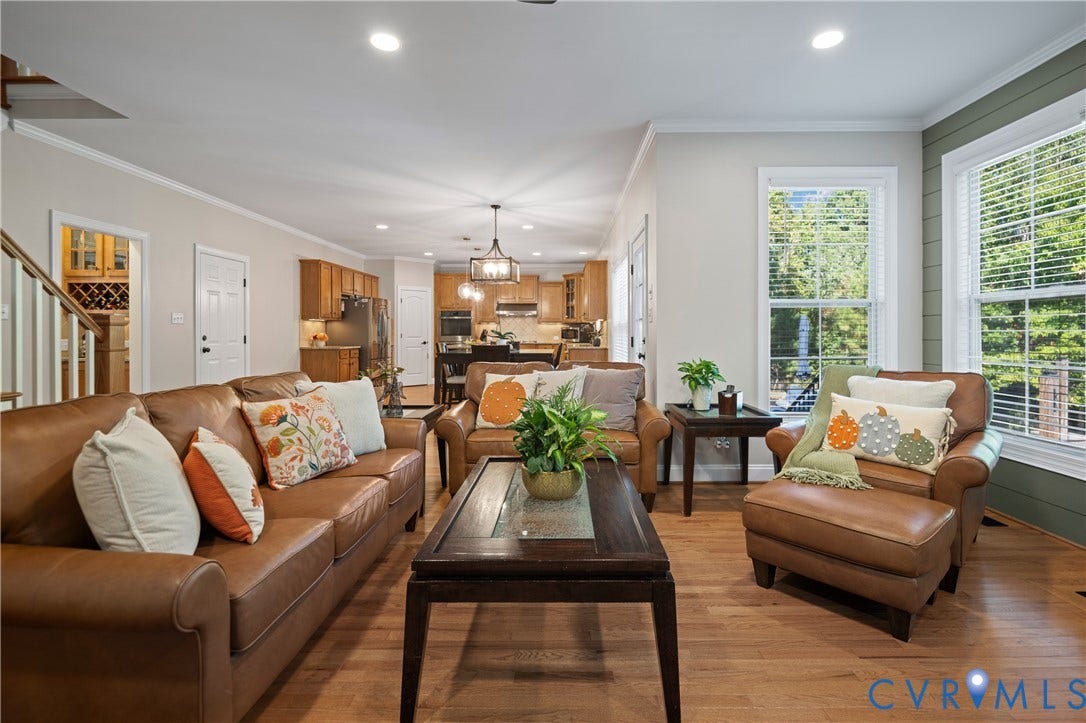 Hardwood flooring throughout, recessed lighting, crown molding, double windows, and a shiplap accent wall