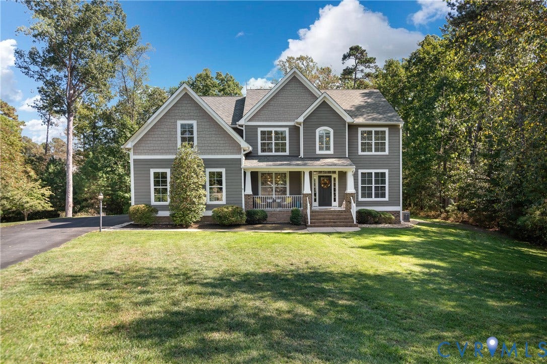 Two-story residence with gray siding and decorative shingle accents