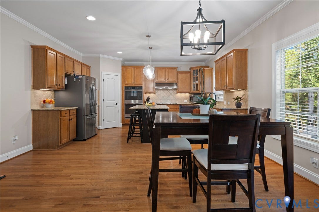 Kitchen featuring wood-finish flooring, recessed lighting, and crown molding