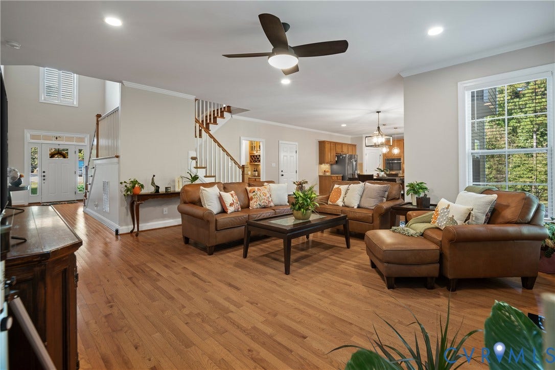 Hardwood flooring throughout, recessed lighting, and a ceiling fan