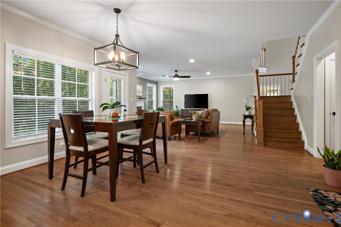 Hardwood flooring, multi-pane windows, a recessed lighting package, and a wood staircase with balusters