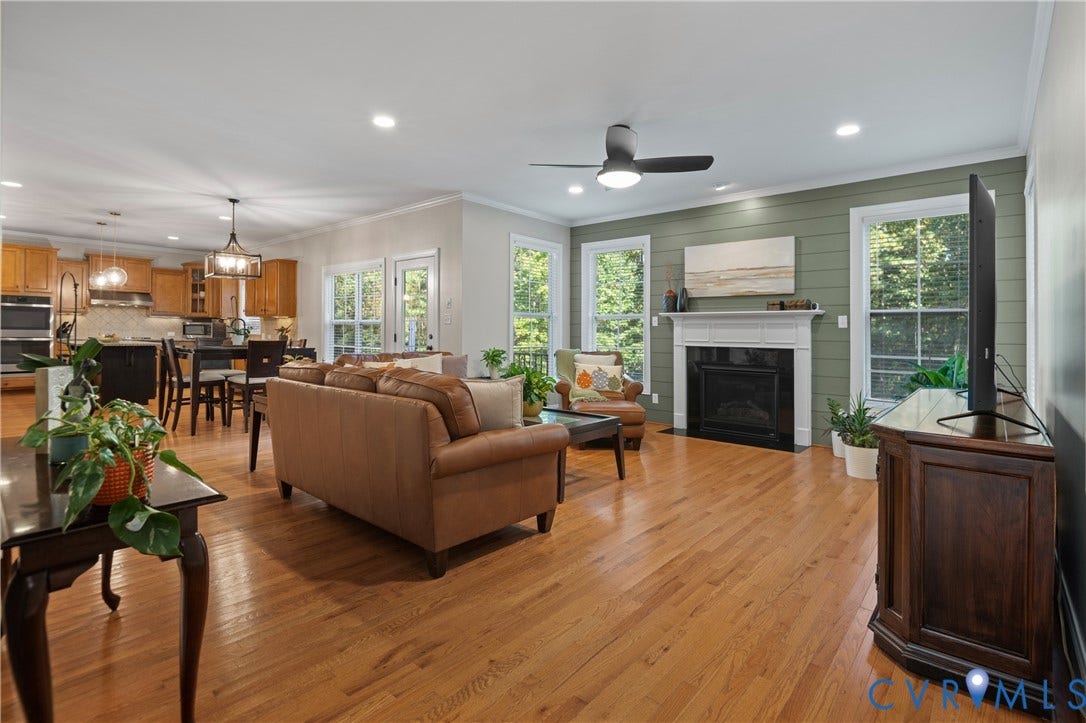 Hardwood flooring throughout, recessed lighting, and a ceiling fan