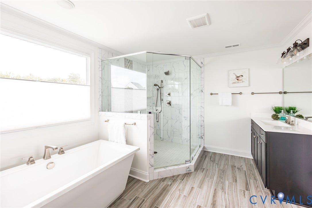 Alternate view of the primary bathroom that shows one of 2 vanity sinks.