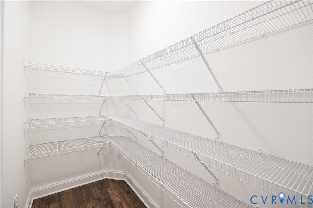 Walk-in pantry with shelves. So much room for your supplies! Also, next to the pantry is an additional storage room for cleaning or pet supplies.