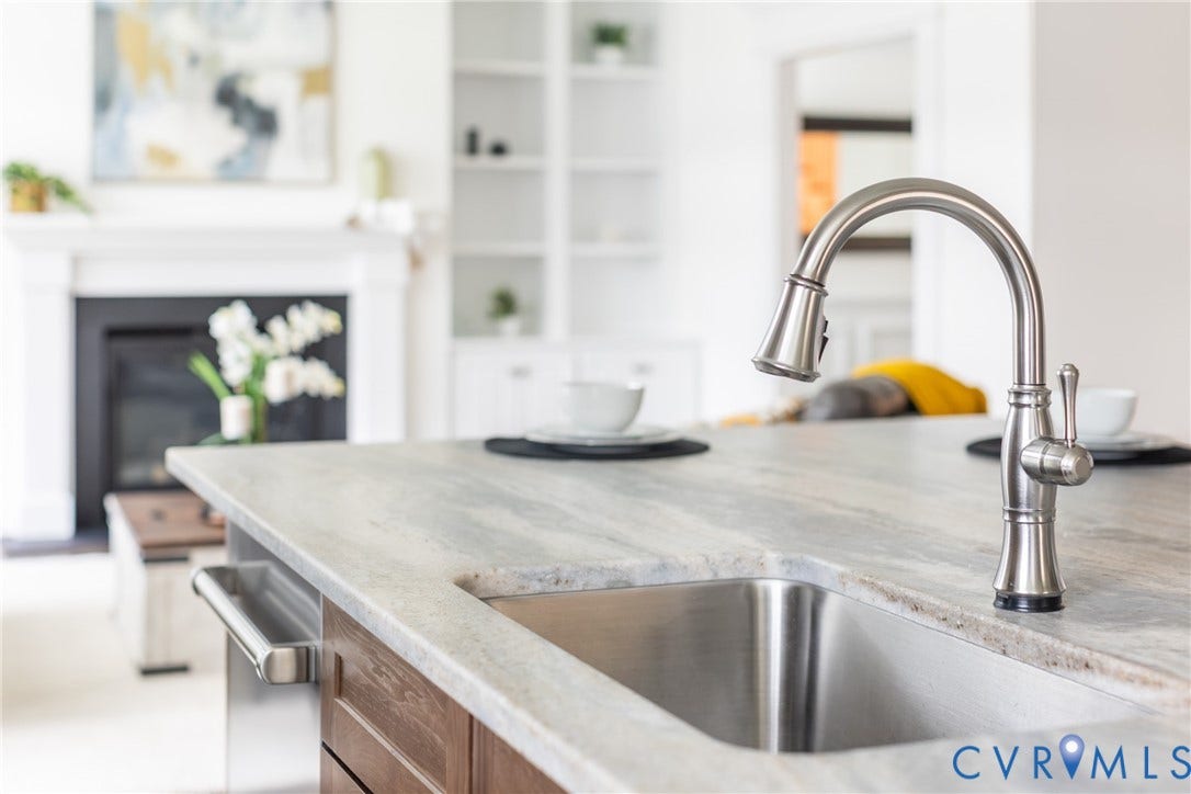 This kitchen is equipped with a high arch stainless steel Delta touchless faucet.