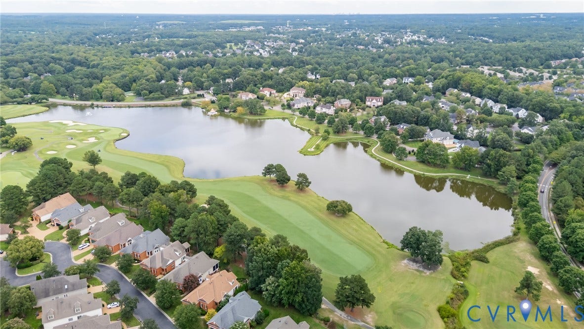 Gorgeous view of the Wyndham lake that is lined with sidewalks and has a gazebo and outdoor amphitheatre style seating where festivals occur throughout the year. The lake is next to the Dominion Club golf course which residents have the option to join for a fee.