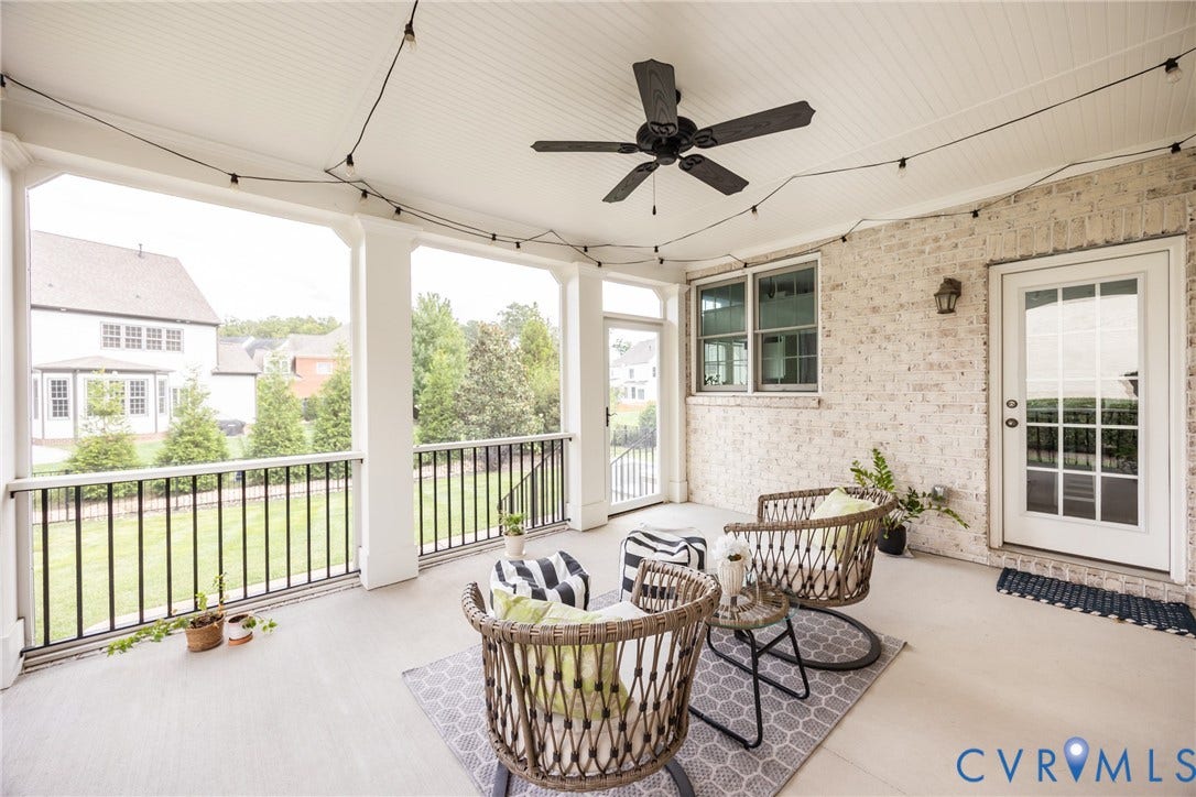Just off of the kitchen is the concrete patio covered screened porch with beadboard ceiling, a ceiling fan, and a glass door that locks for added security.