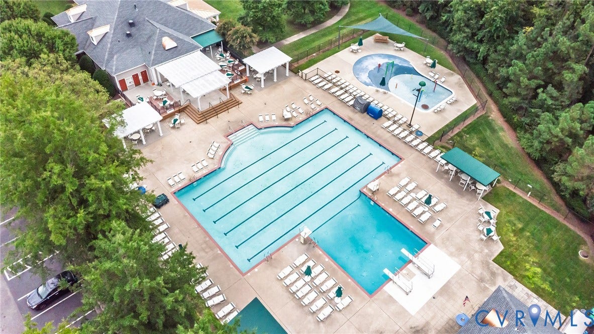 Aerial view of the Wyndham lifestyle with swimming pools, including a lap pool and a splash pad/kiddie pool and a clubhouse.