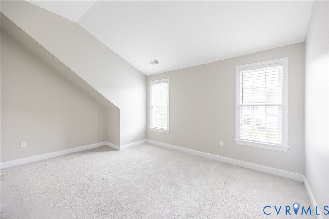 Bedroom six has sloped walls and windows that allow natural light to flow.