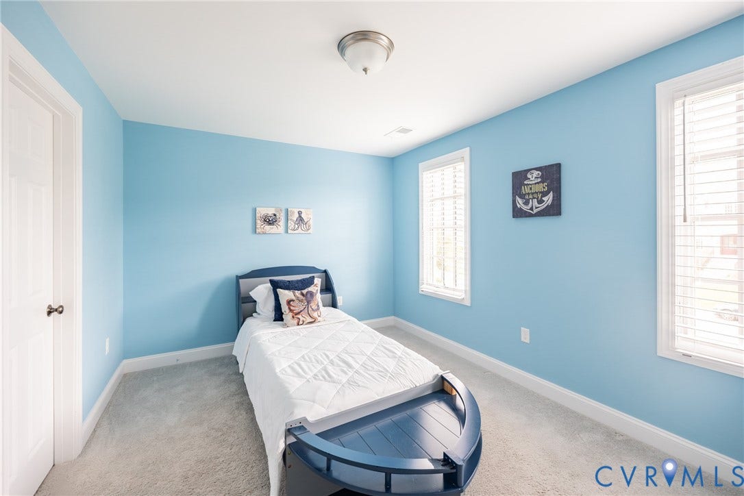 Bedroom three with two closets, 2 windows and it connect to a jack and jill full bathroom.