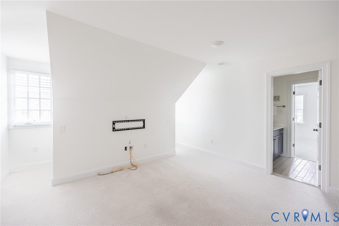 Third floor bonus room for the ultimate space for a variety of uses! To the right you can see the full bathroom that connects to a bedroom. The bedroom has a separate entrance not seen in this photo.
