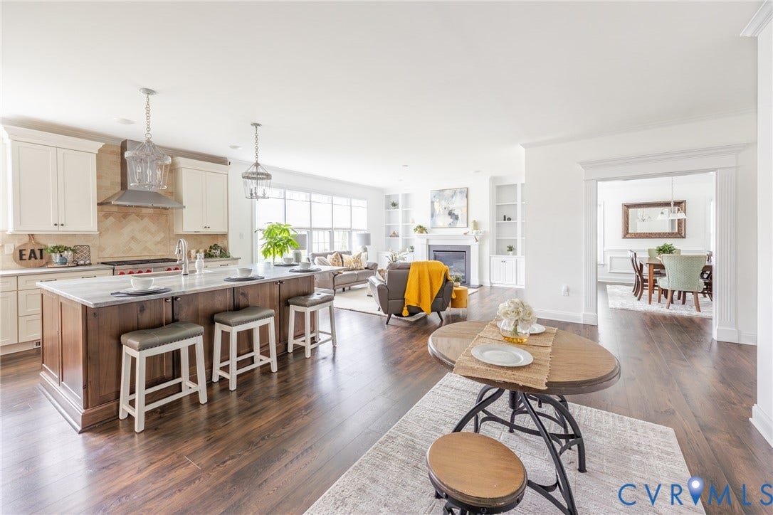 View of the eat-in kitchen that opens to the large family room. The formal dining room is seen to the right in the background.