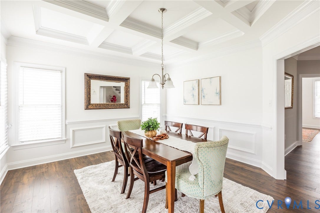 Formal dining room with coffered ceiling, crown molding, chair rail with panel molding