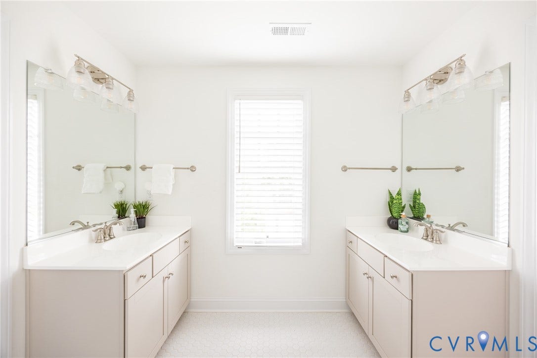Jack and Jill bathroom with dual vanities, undermount sinks, and brushed nickel hardware.