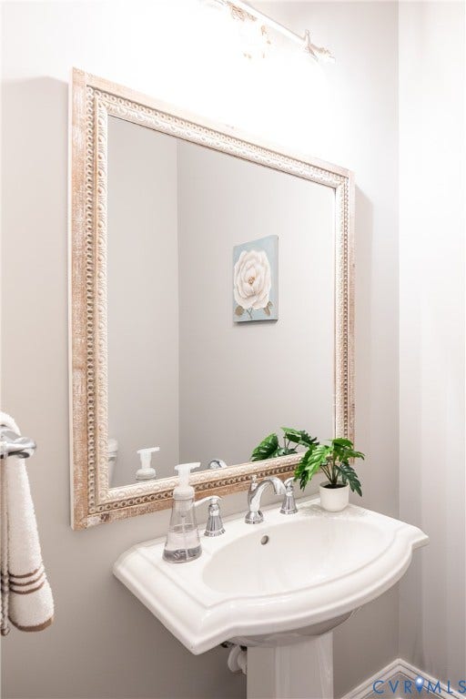 The half bath is tucked away in the hallway to the mudroom and garage.