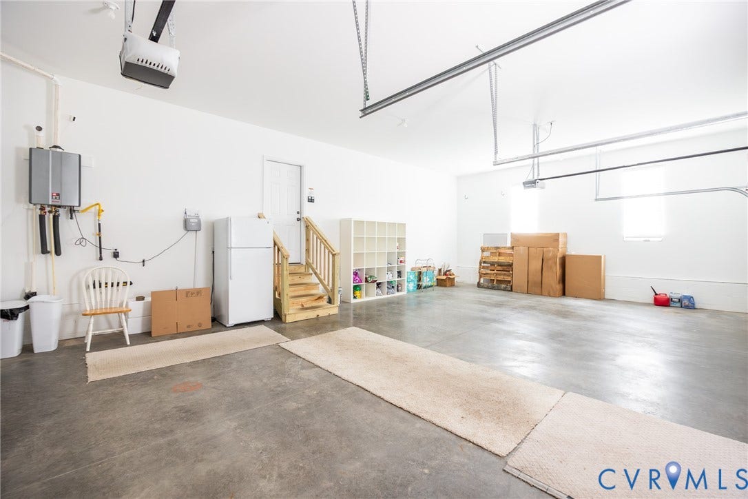 Large three car garage with utility sink.
