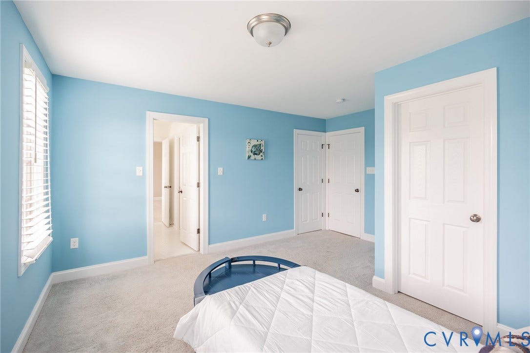 Alternate view of bedroom three looking into the jack and jill full bathroom. This room has two closets for clothing and storage.