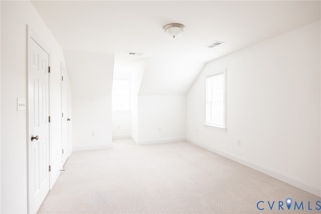 Third floor bedroom seven with dormer window, closet and attached full bathroom.
