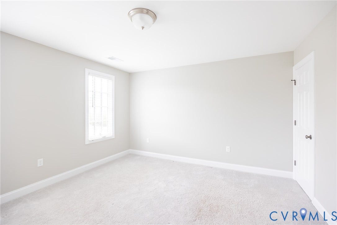 Bedroom four with a large closet and two windows.