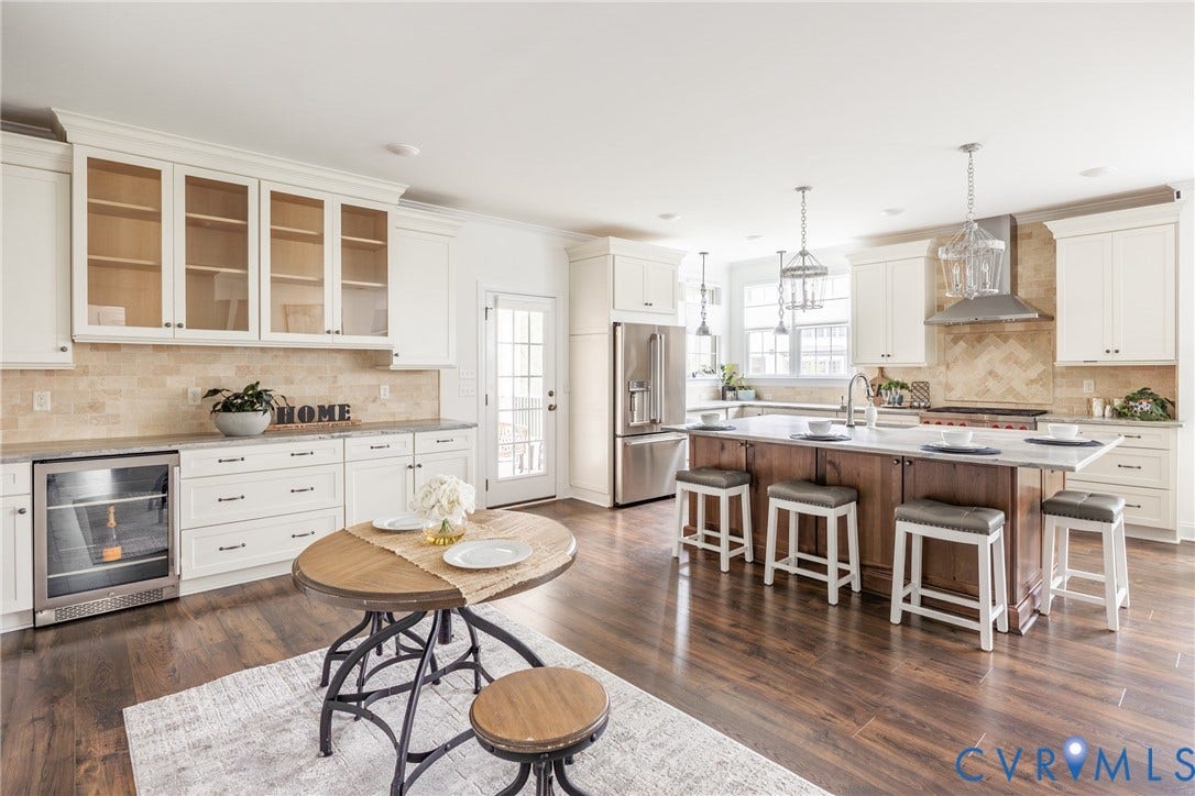 View of the large chef's kitchen with an eat in area.
