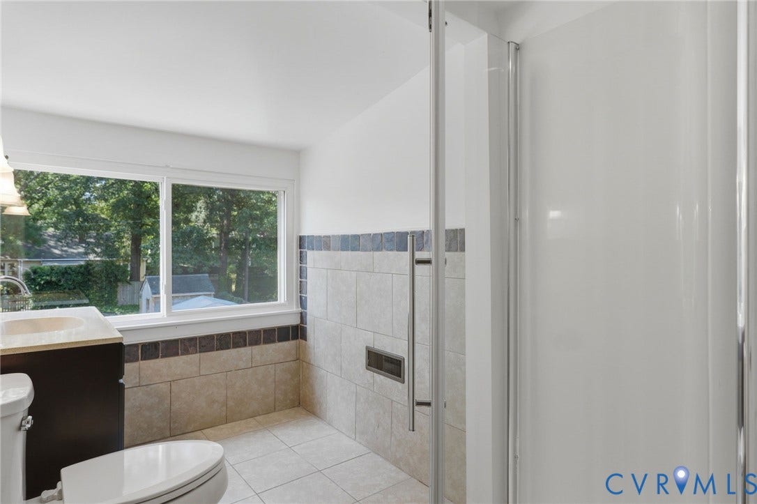 5108 Forest Hill Avenue, Westover Hills Area, Richmond, VA 23225 2nd floor full bathroom with white tiled flooring, vanity, large pane window, tiled walls, and a glass-enclosed shower