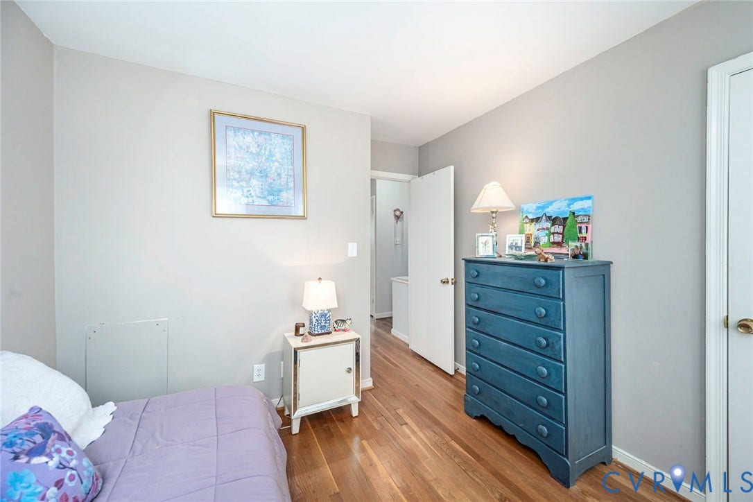 Hardwood flooring throughout, neutral wall finishes, and white trim