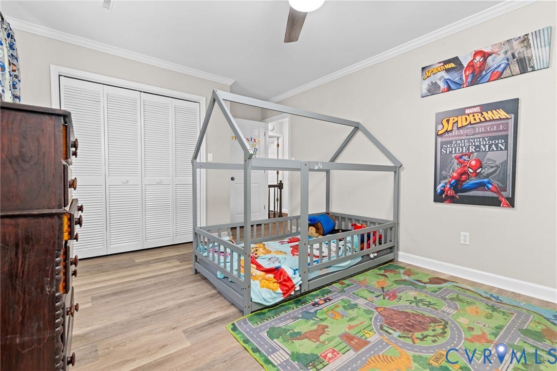 Light-toned wood-finish flooring complements the neutral wall color